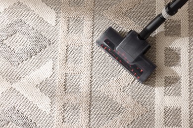 Photo of One vacuum cleaner nozzle on carpet, top view. Space for text