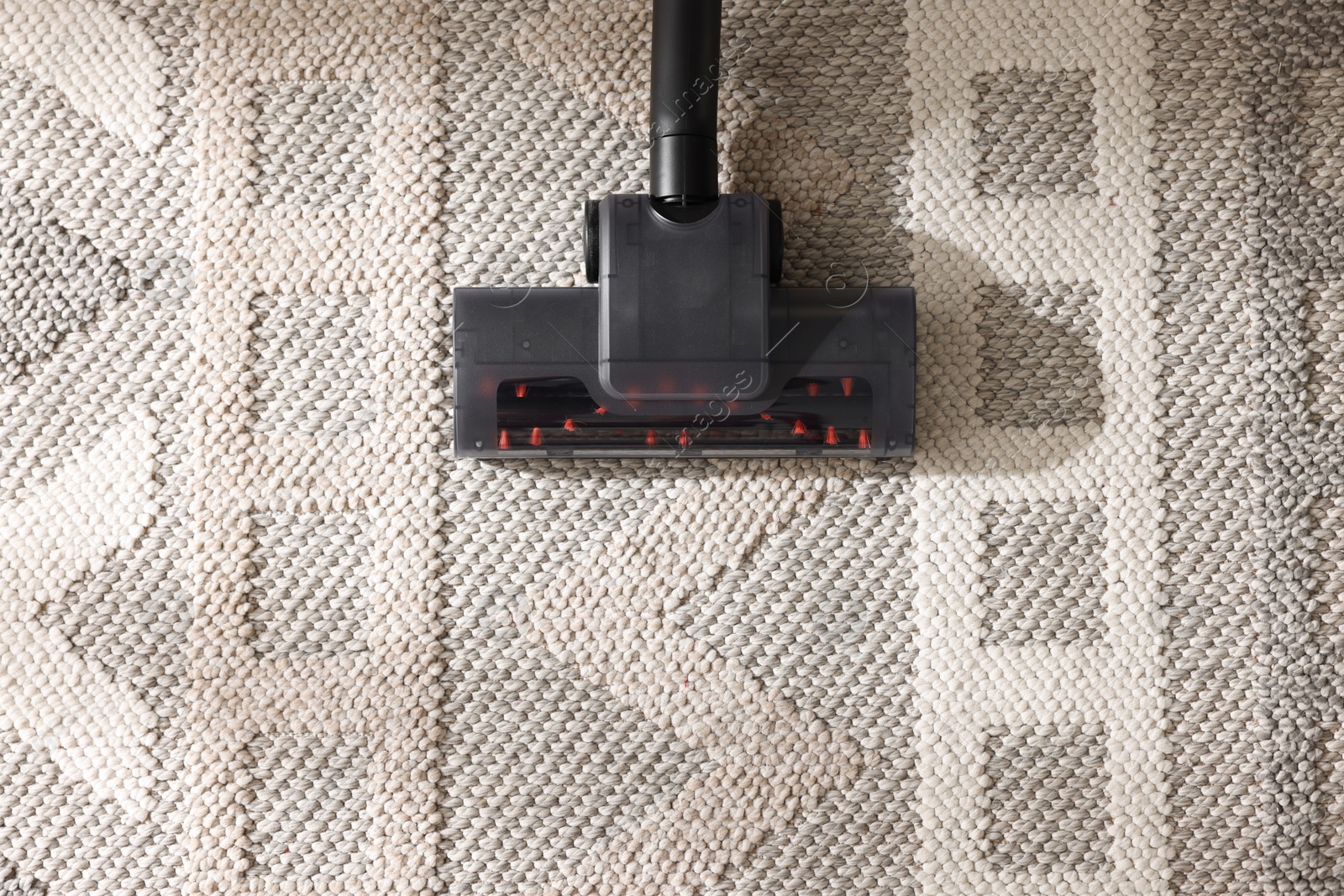 One vacuum cleaner nozzle on carpet, top view. Space for text Photo of One vacuum cleaner nozzle on carpet, top view. Space for text