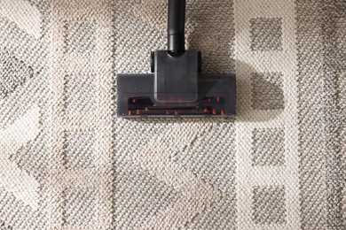 Photo of One vacuum cleaner nozzle on carpet, top view. Space for text