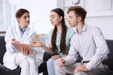 Photo of In vitro fertilization (IVF). Couple having appointment with doctor in reproductive clinic