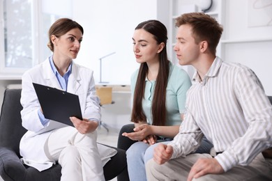 Photo of In vitro fertilization (IVF). Couple having appointment with doctor in reproductive clinic