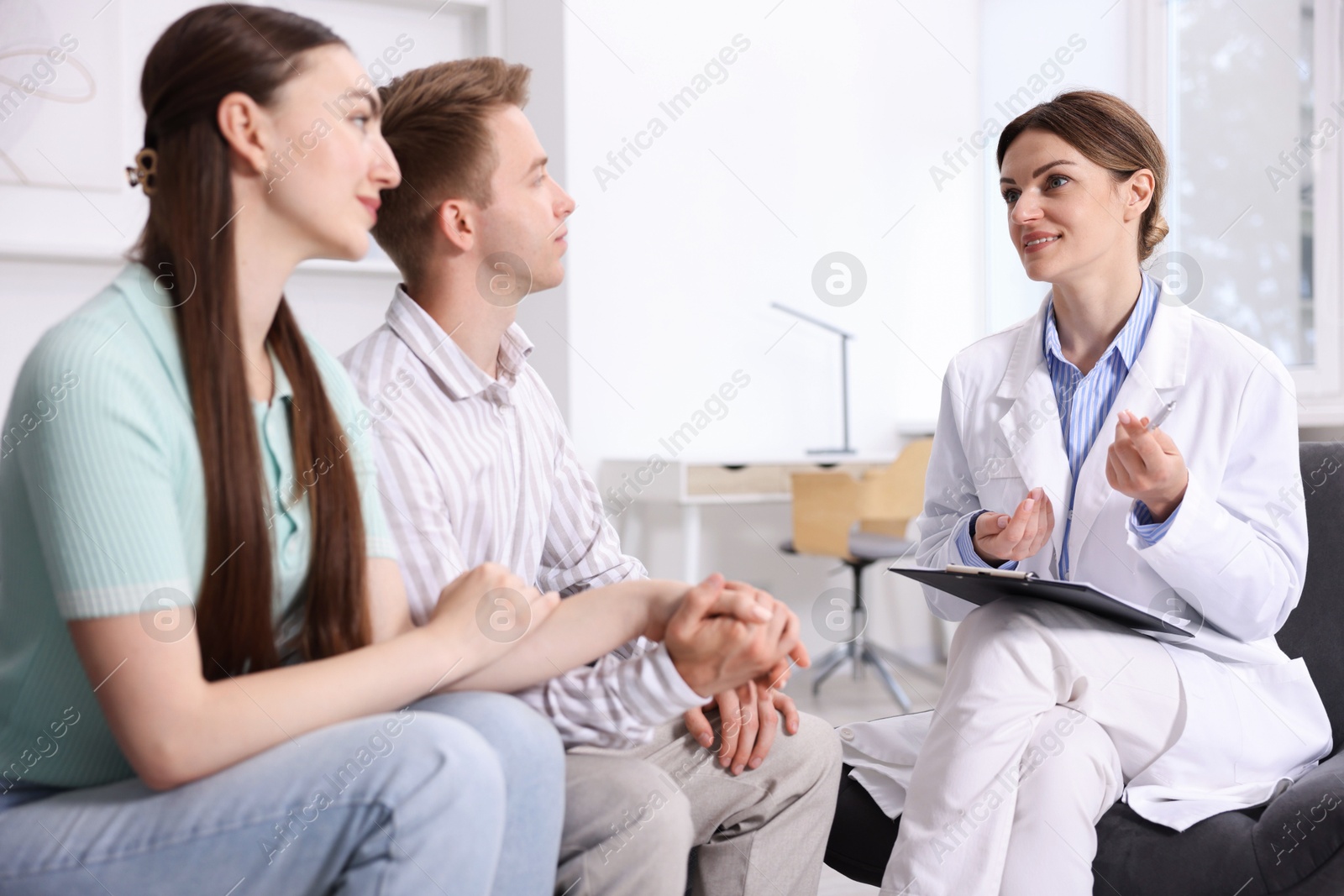 In vitro fertilization (IVF). Couple having appointment with doctor in reproductive clinic Photo of In vitro fertilization (IVF). Couple having appointment with doctor in reproductive clinic