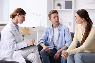 Photo of In vitro fertilization (IVF). Couple having appointment with doctor in reproductive clinic