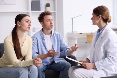 Photo of In vitro fertilization (IVF). Couple having appointment with doctor in reproductive clinic