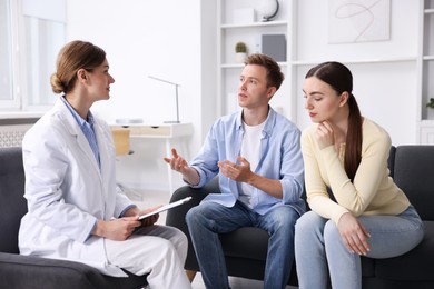 Photo of In vitro fertilization (IVF). Couple having appointment with doctor in reproductive clinic