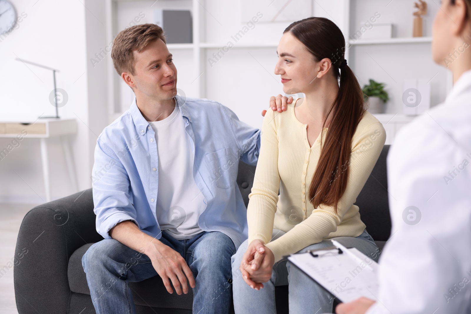In vitro fertilization (IVF). Couple having appointment with doctor in reproductive clinic Photo of In vitro fertilization (IVF). Couple having appointment with doctor in reproductive clinic