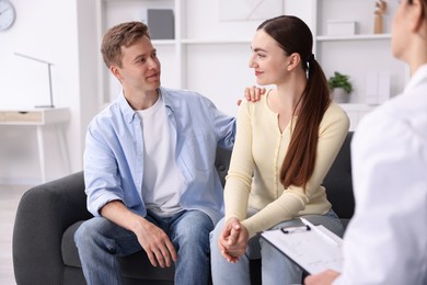 Photo of In vitro fertilization (IVF). Couple having appointment with doctor in reproductive clinic