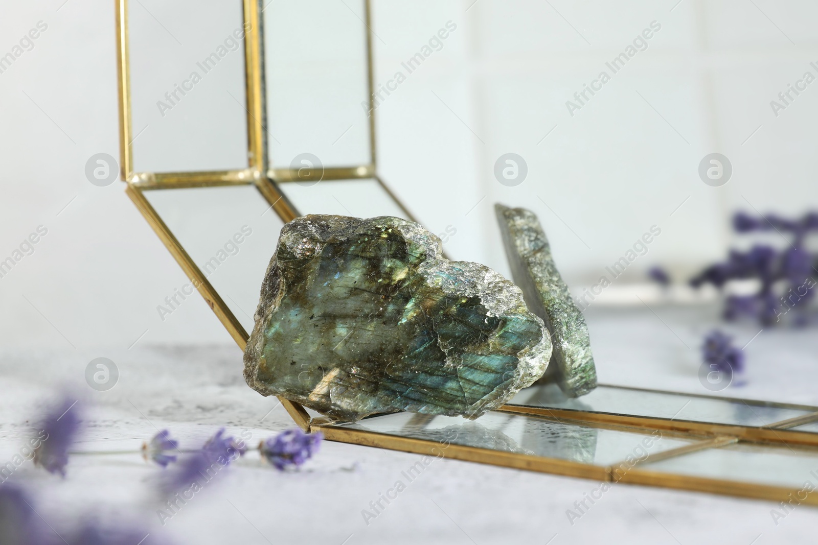Photo of Aura. Beautiful labradorite and lavender on white textured table, closeup