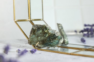 Photo of Aura. Beautiful labradorite and lavender on white textured table, closeup