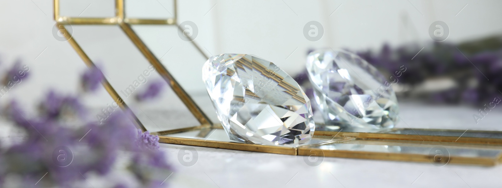 Photo of Aura. Beautiful diamond and lavender on white table, closeup