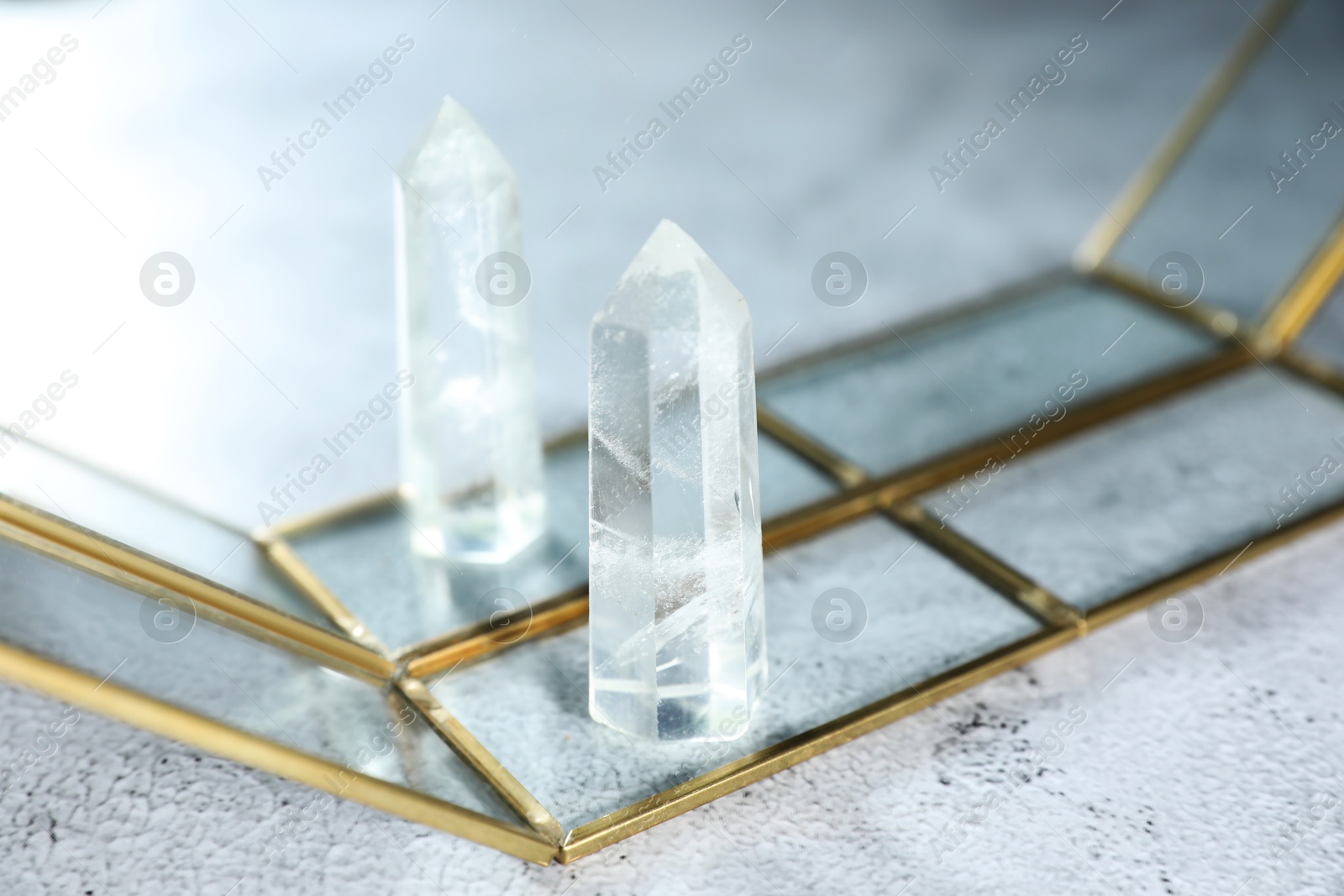 Aura. Beautiful crystal on white textured table, closeup. Space for text Photo of Aura. Beautiful crystal on white textured table, closeup. Space for text