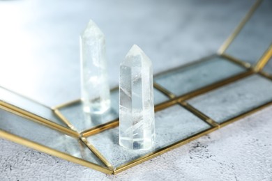 Photo of Aura. Beautiful crystal on white textured table, closeup. Space for text