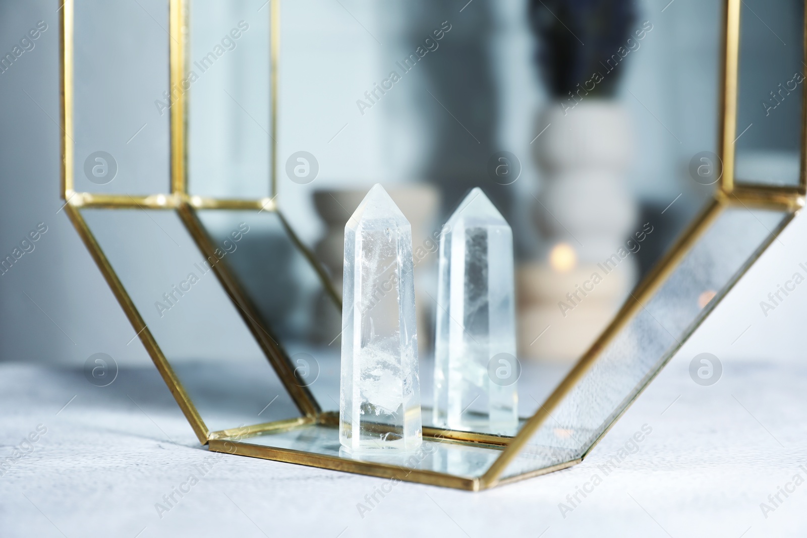 Photo of Aura. Beautiful crystal on white textured table, closeup