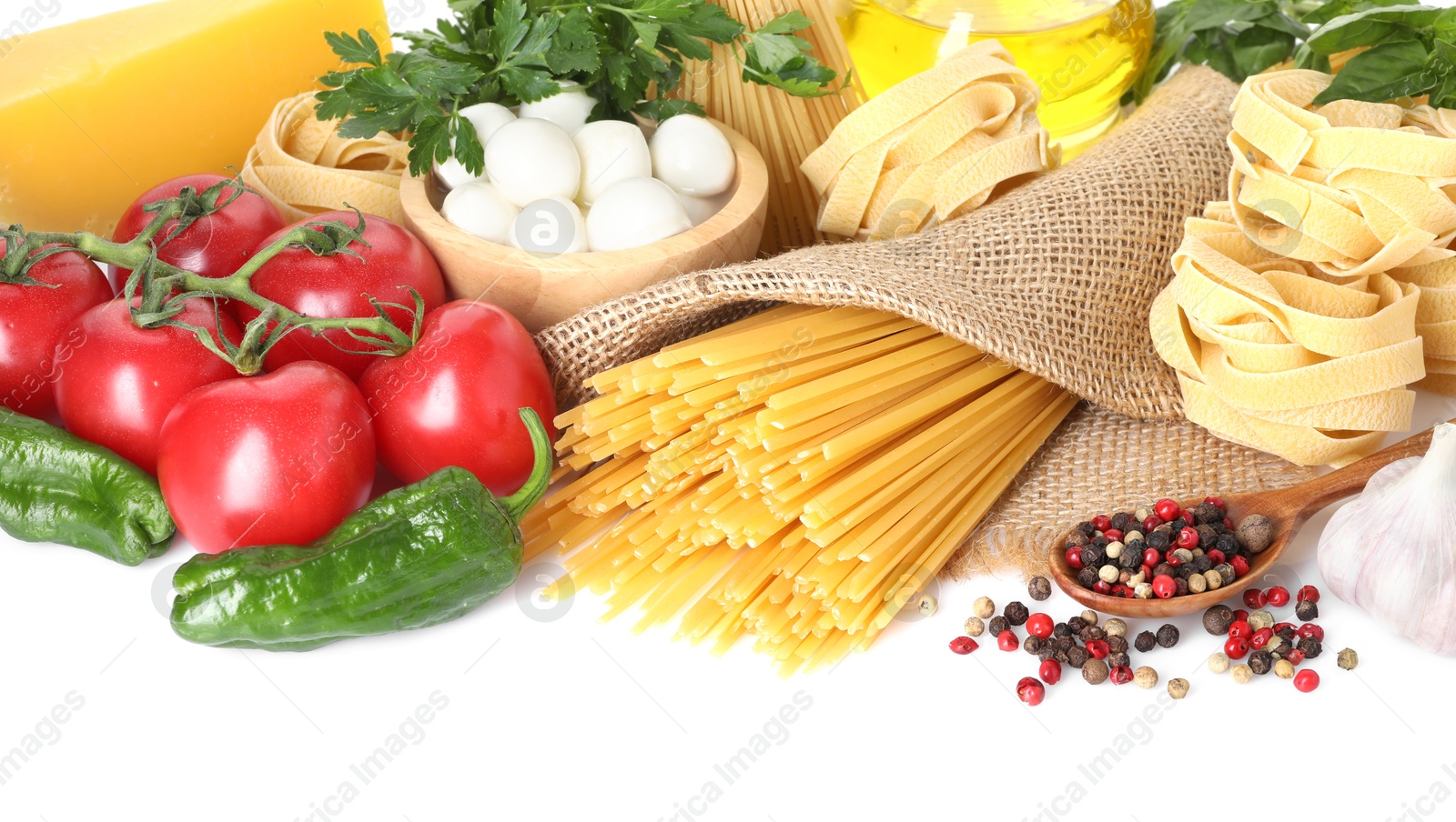 Photo of Different types of pasta and ingredients isolated on white