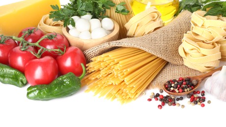 Photo of Different types of pasta and ingredients isolated on white
