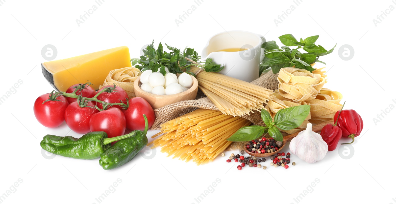 Photo of Different types of pasta and ingredients isolated on white