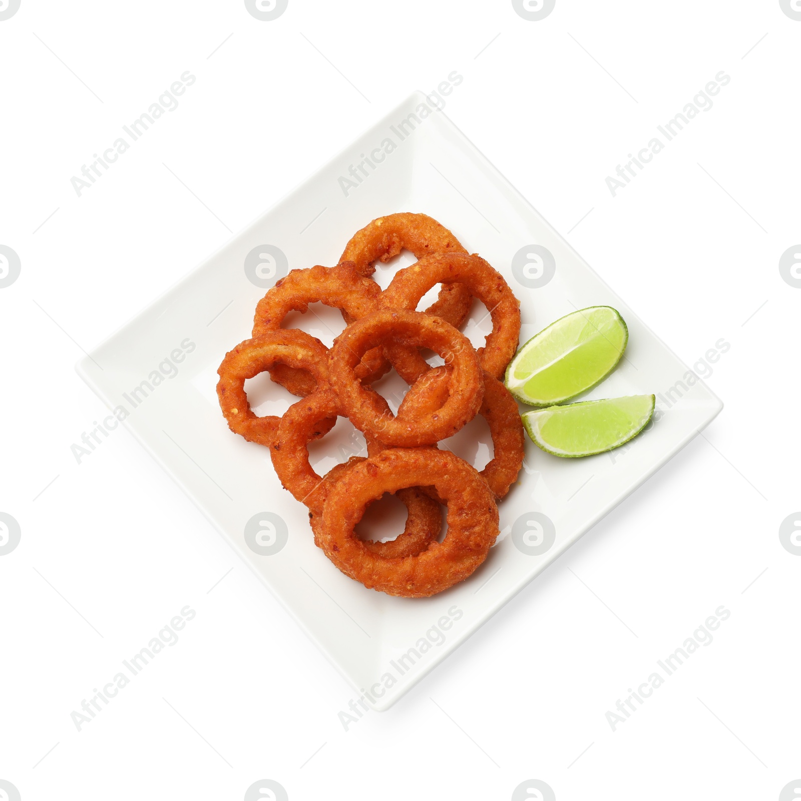 Photo of Fried squid rings and lime isolated on white, top view