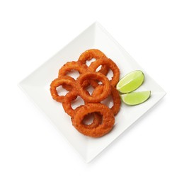 Photo of Fried squid rings and lime isolated on white, top view