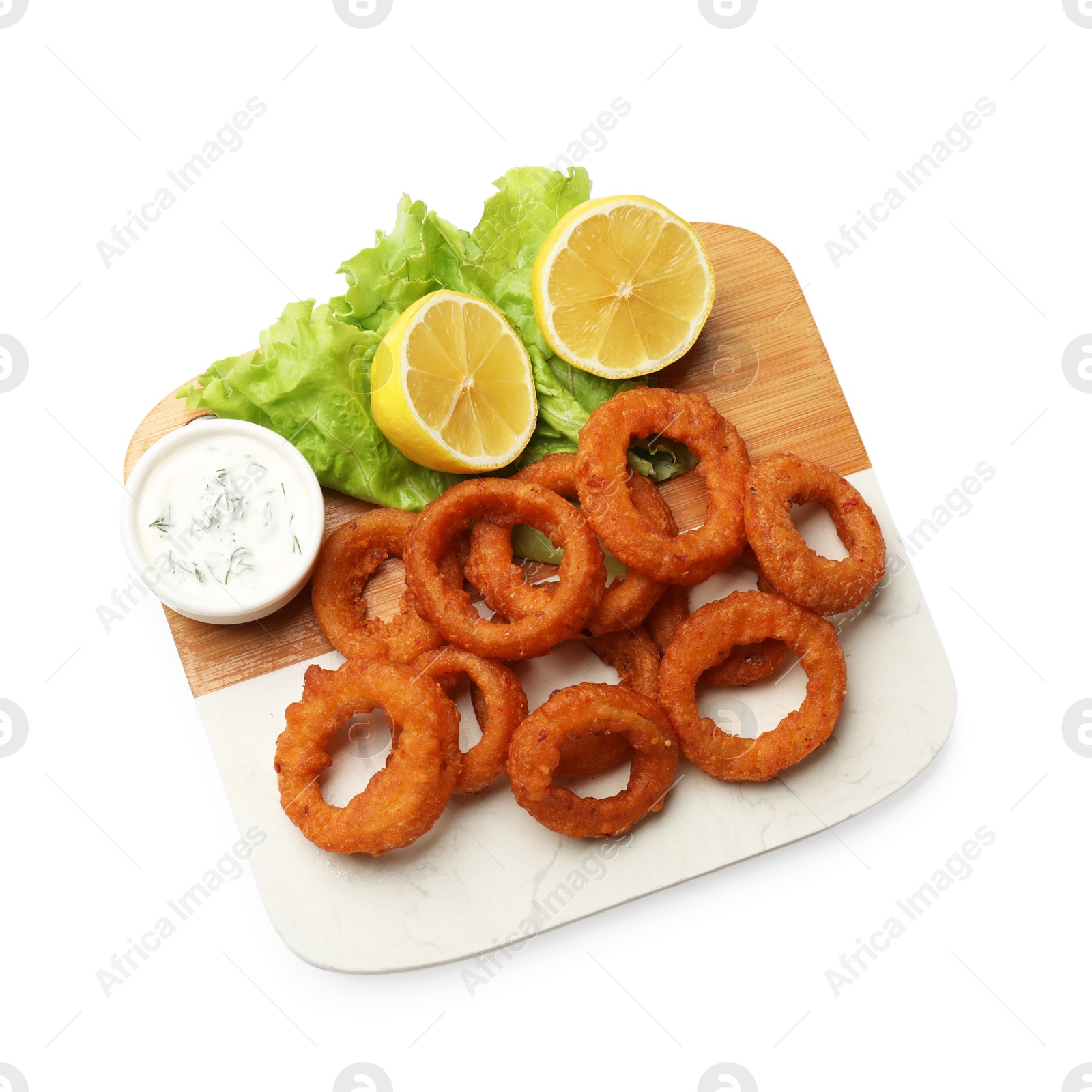 Photo of Fried squid rings, lemon, lettuce and sauce isolated on white, top view