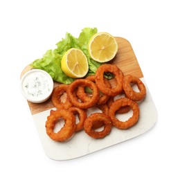 Photo of Fried squid rings, lemon, lettuce and sauce isolated on white, top view