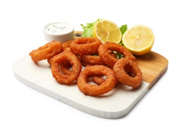 Photo of Fried squid rings, lemon, lettuce and sauce isolated on white