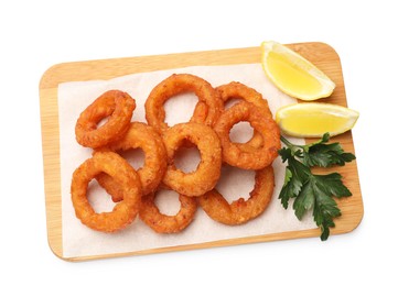 Photo of Fried squid rings with parsley and lemon isolated on white, top view
