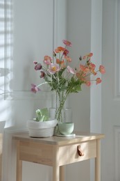 Photo of Bedside table with different decor at home