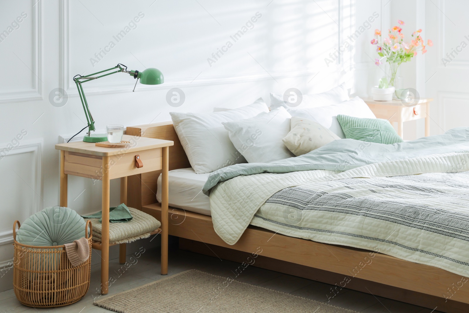 Photo of Bedside tables with decor near bed indoors