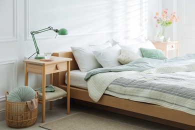 Photo of Bedside tables with decor near bed indoors