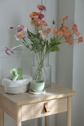 Photo of Bedside table with different decor at home