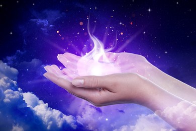 Image of Woman creating bright light among clouds in sky, closeup. Aura, spiritual practice