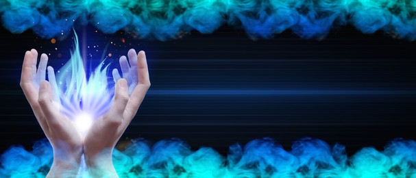 Image of Man creating bright light in smoke against black background, banner design. Aura, spiritual practice