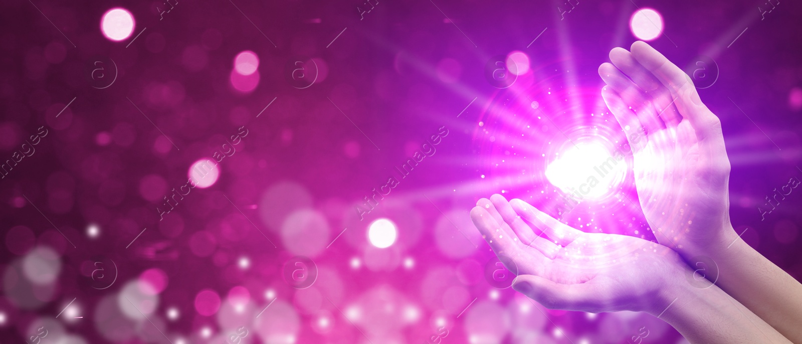 Man creating bright light against pink background, banner design. Aura, spiritual practice Image of Man creating bright light against pink background, banner design. Aura, spiritual practice