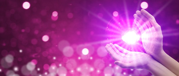 Image of Man creating bright light against pink background, banner design. Aura, spiritual practice