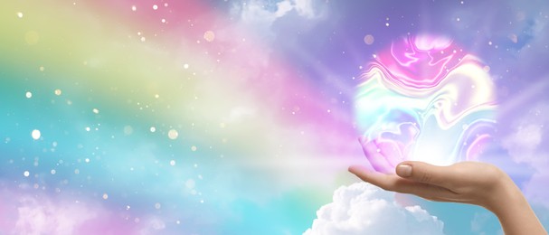 Image of Woman holding iridescent sphere against rainbow sky, banner design. Aura, spiritual practice