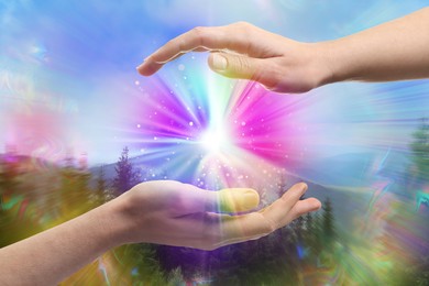 Image of Man and woman creating bright light in mountains. Aura, spiritual practice