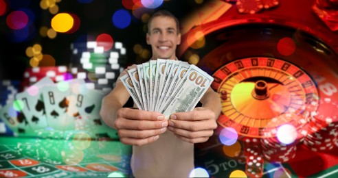 Image of Gambler with money fan, casino chips, dice, playing cards and roulette. Banner design
