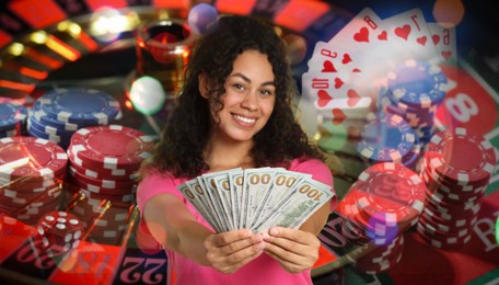 Image of Gambler with money fan, casino chips, playing cards, dice and roulette. Banner design
