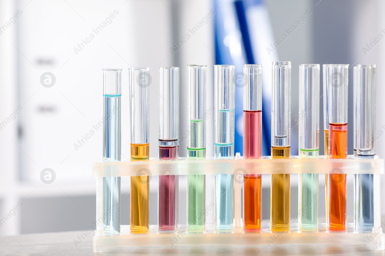 Photo of Test tubes with different samples on table in laboratory, closeup. Solution chemistry