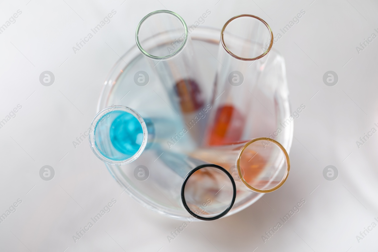 Photo of Test tubes with different samples on white table, top view. Solution chemistry