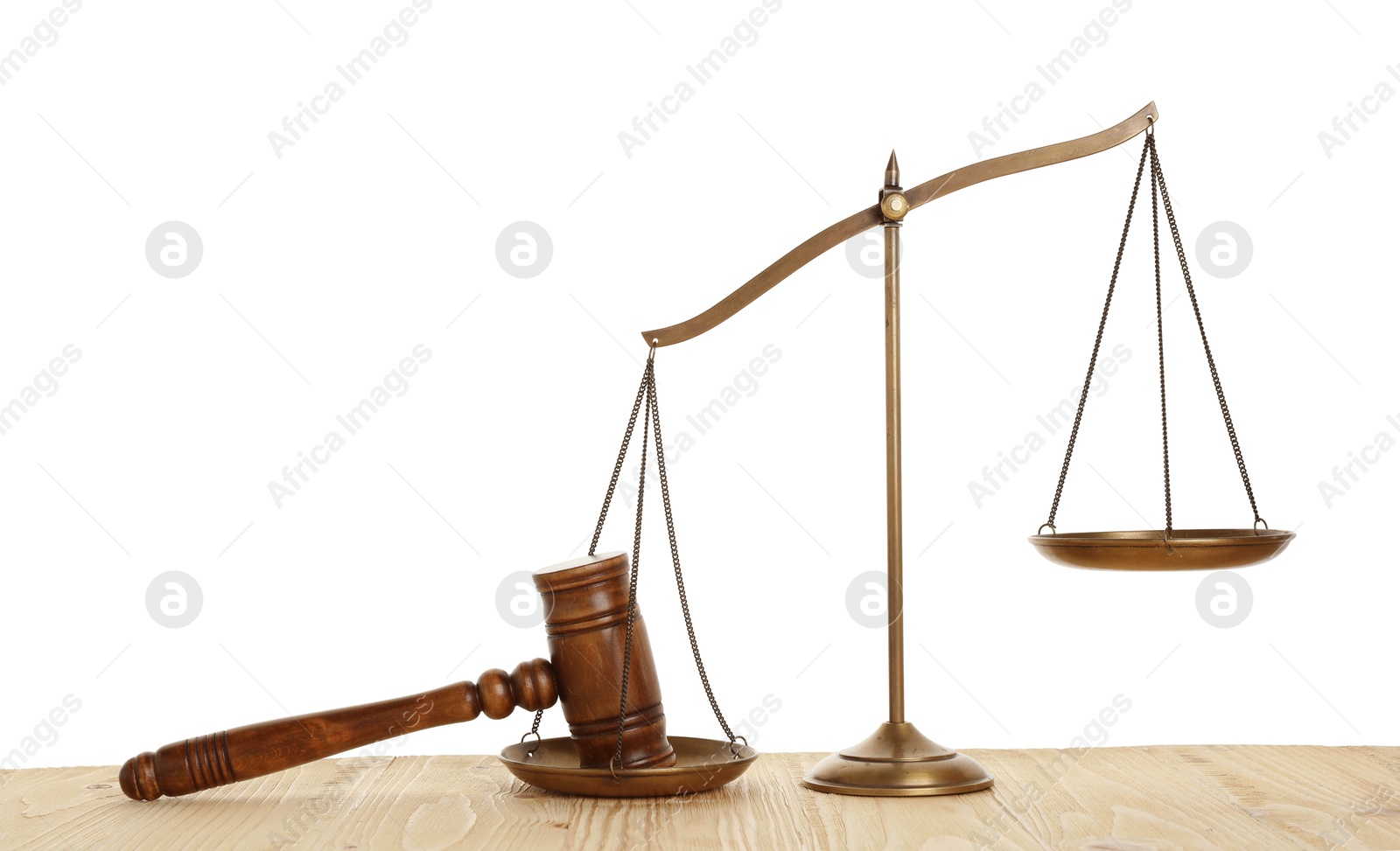 Photo of Golden scales of justice and gavel on wooden table against white background
