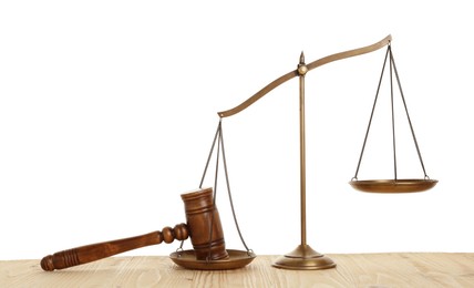 Photo of Golden scales of justice and gavel on wooden table against white background