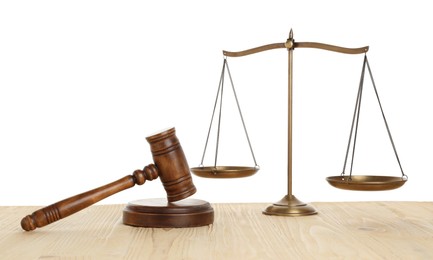 Photo of Golden scales of justice and gavel on wooden table against white background