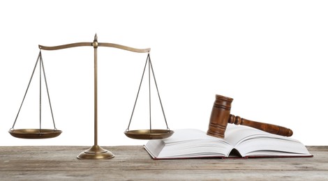 Photo of Golden scales of justice, book and gavel on wooden table against white background