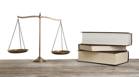 Photo of Golden scales of justice and books on wooden table against white background