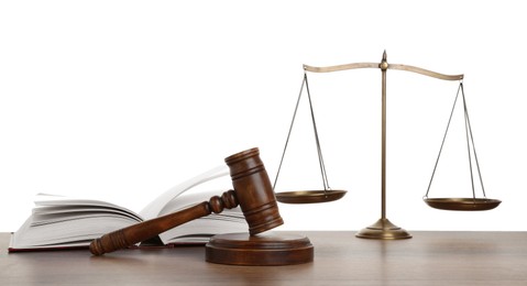 Photo of Golden scales of justice, book and gavel on wooden table against white background
