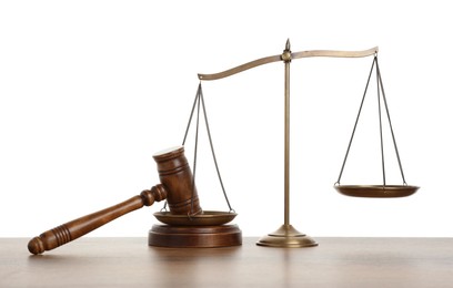 Photo of Golden scales of justice and gavel on wooden table against white background