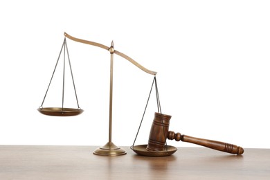 Photo of Golden scales of justice and gavel on wooden table against white background