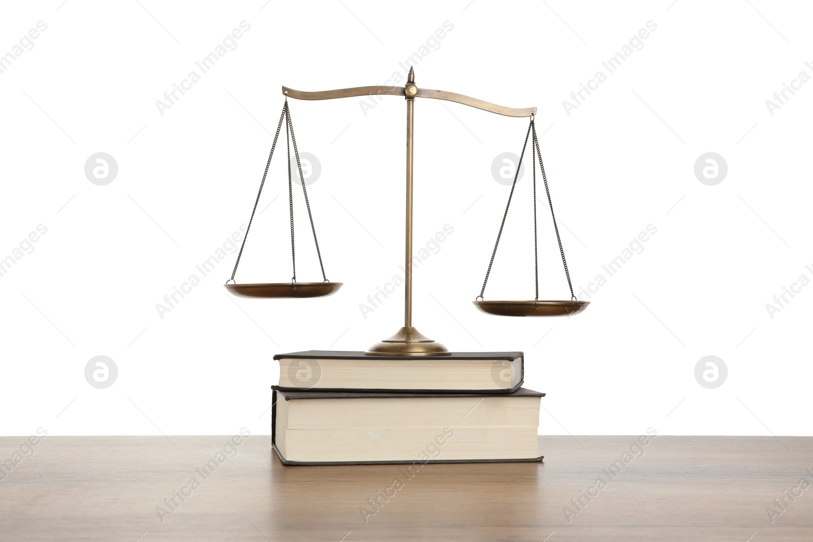 Golden scales of justice and books on wooden table against white background Photo of Golden scales of justice and books on wooden table against white background