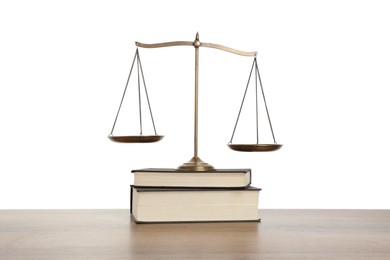 Photo of Golden scales of justice and books on wooden table against white background